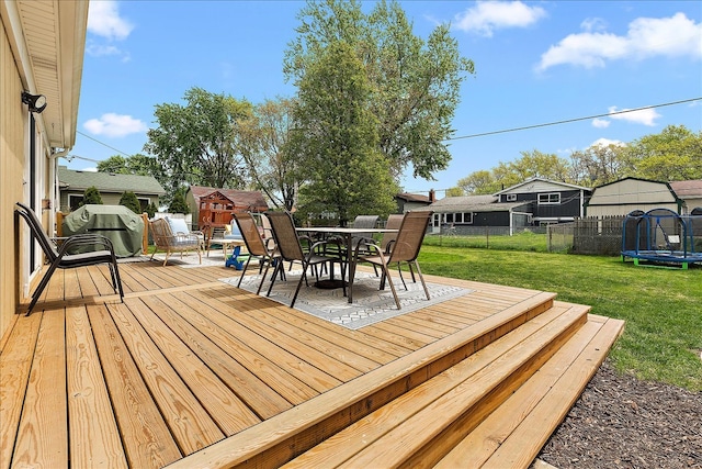 deck with a trampoline and outdoor dining space