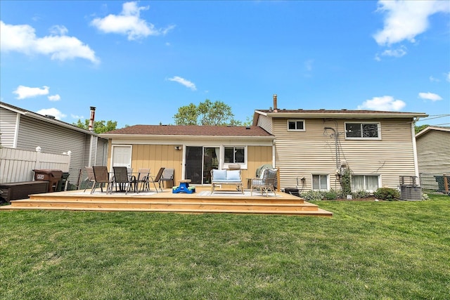 rear view of property featuring a yard, a deck, central AC, and outdoor dining space