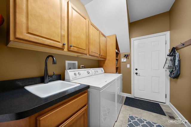 laundry area featuring cabinet space, washer and clothes dryer, light tile patterned floors, and baseboards