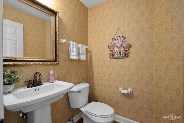 bathroom with toilet and a sink