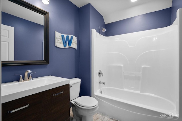 bathroom with toilet, vanity, bathing tub / shower combination, and wood finished floors