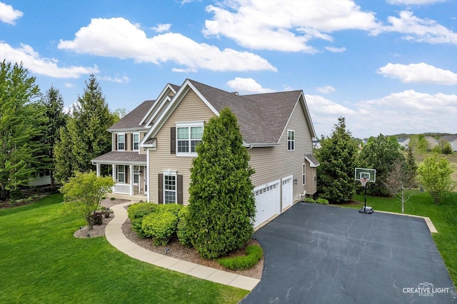 view of side of property with a shingled roof, a yard, asphalt driveway, and an attached garage