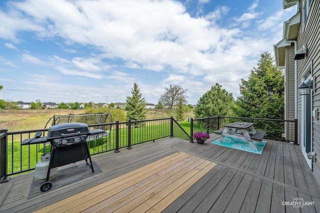 deck with a grill and a yard