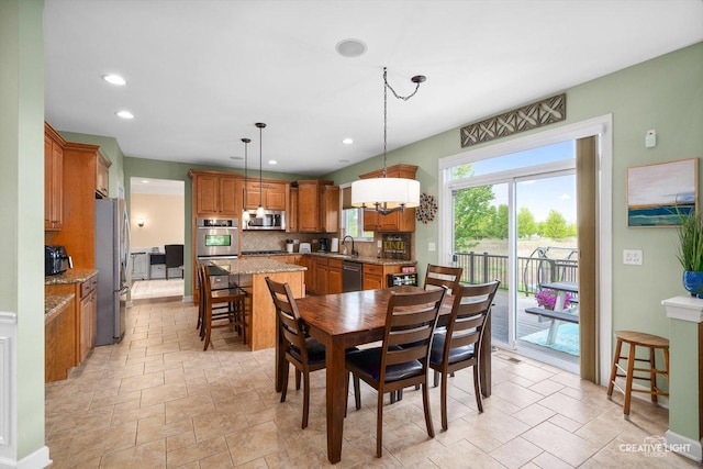 dining space with recessed lighting and light stone finish floors