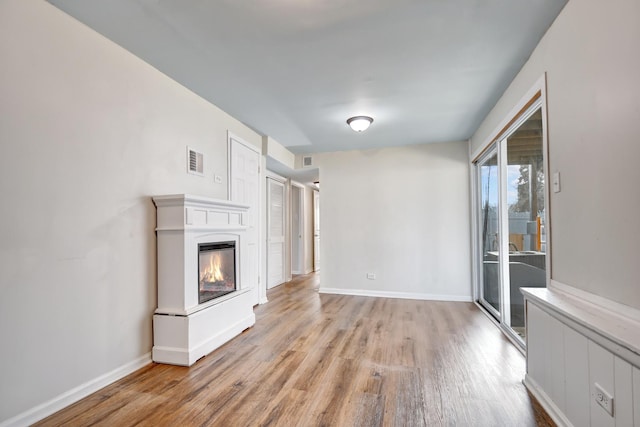 530 Parnell Ave, Chicago Heights, IL 60411 - unfurnished living room featuring wood finished floors, baseboards, and a glass covered fireplace