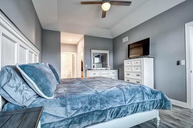 bedroom with wood finished floors, baseboards, a ceiling fan, and ensuite bathroom