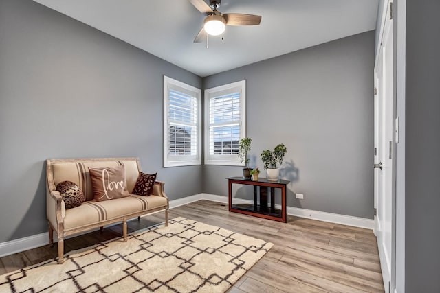 sitting room featuring ceiling fan, baseboards, and wood finished floors