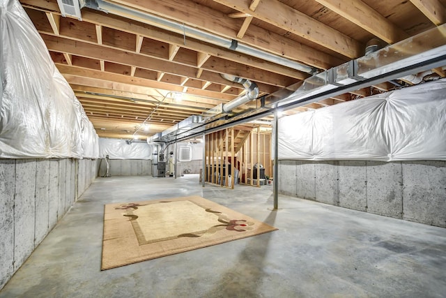 unfinished basement featuring heating unit