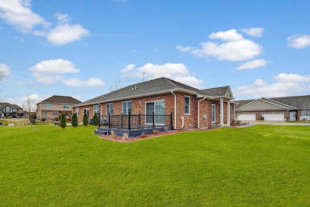 back of house featuring brick siding, a garage, a lawn, driveway, and a shingled roof
