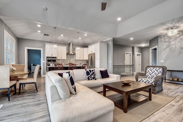 living area with vaulted ceiling, light wood-style flooring, recessed lighting, baseboards, and a ceiling fan