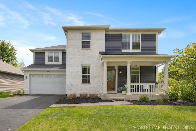 700 Wilmore Dr, Oswego, IL 60543 - view of front of home with driveway, covered porch, a garage, and a front lawn