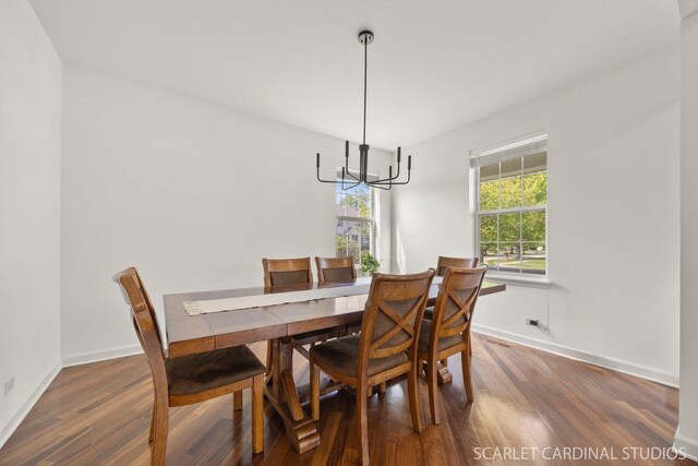 700 Wilmore Dr, Oswego, IL 60543 - dining area featuring a chandelier, wood finished floors, and baseboards