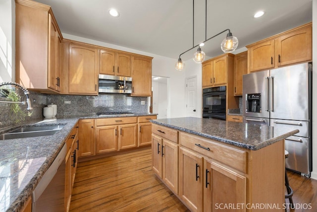 700 Wilmore Dr, Oswego, IL 60543 - kitchen with appliances with stainless steel finishes, a sink, tasteful backsplash, wood finished floors, and recessed lighting