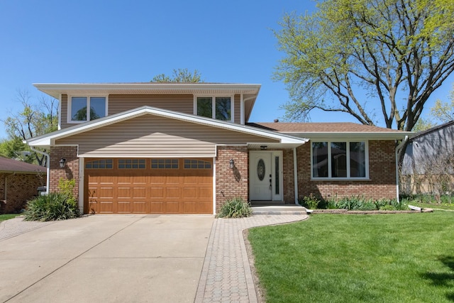12 James Dr, Westmont, IL 60559 - tri-level home with brick siding, concrete driveway, a front lawn, and an attached garage