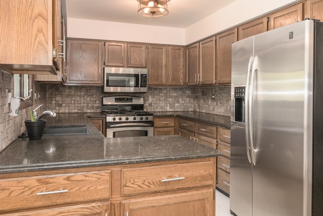 12 James Dr, Westmont, IL 60559 - kitchen featuring stainless steel appliances, a sink, backsplash, and dark stone counters
