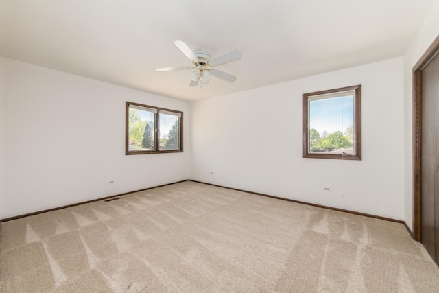 12 James Dr, Westmont, IL 60559 - unfurnished bedroom with light colored carpet, baseboards, and ceiling fan