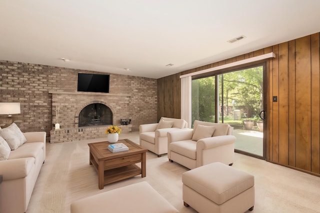 12 James Dr, Westmont, IL 60559 - living area featuring light colored carpet, wood walls, a brick fireplace, and brick wall