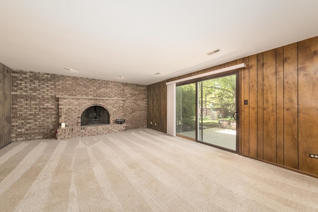 12 James Dr, Westmont, IL 60559 - unfurnished living room featuring wood walls, a fireplace, carpet, and brick wall