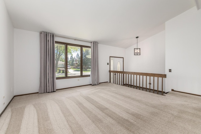 12 James Dr, Westmont, IL 60559 - carpeted empty room featuring lofted ceiling, baseboards, and a chandelier