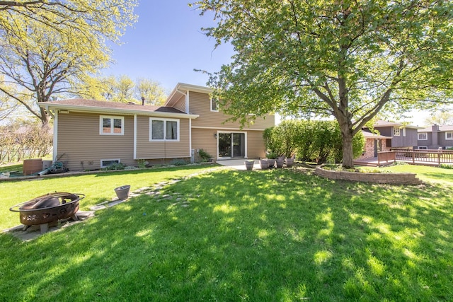 12 James Dr, Westmont, IL 60559 - rear view of property featuring a fire pit, a deck, a lawn, and a patio area