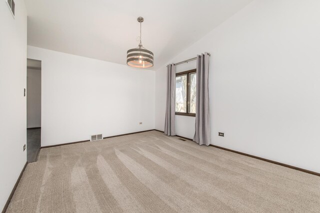 12 James Dr, Westmont, IL 60559 - empty room with vaulted ceiling, carpet floors, and baseboards