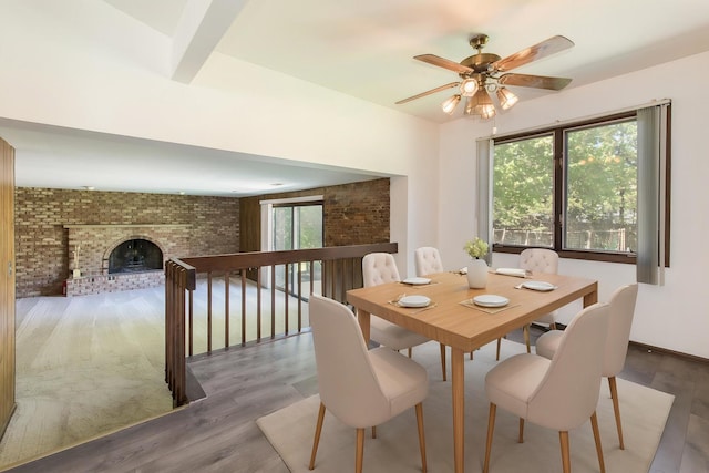 12 James Dr, Westmont, IL 60559 - dining space featuring healthy amount of natural light, a ceiling fan, wood finished floors, and a brick fireplace