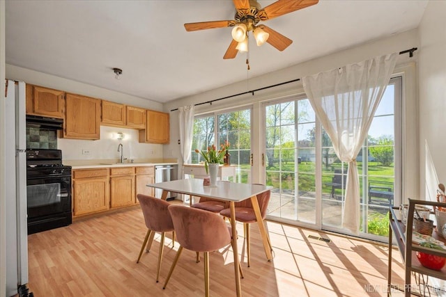 dining space featuring light wood finished floors and a ceiling fan