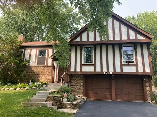 1916 Saginaw Ct, Naperville, IL 60565 - tudor home featuring brick siding, a garage, asphalt driveway, a chimney, and a front lawn