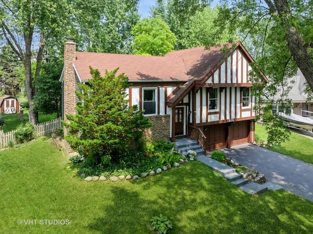 1916 Saginaw Ct, Naperville, IL 60565 - tudor-style house featuring asphalt driveway, a chimney, an attached garage, and a shingled roof