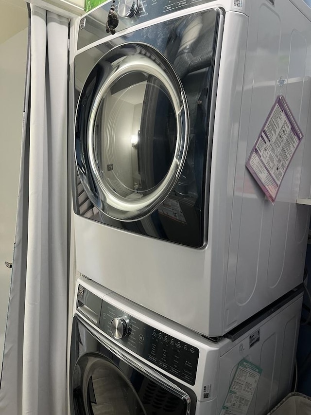laundry room with stacked washer / drying machine