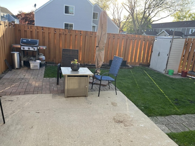view of patio featuring a storage unit, an outbuilding, and area for grilling