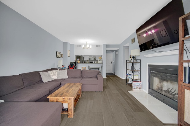 511 Aurora Ave Unit 413, Naperville, IL 60540 - living area with a chandelier, a fireplace with flush hearth, and wood finished floors