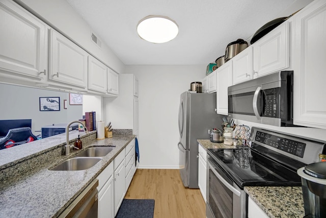 511 Aurora Ave Unit 413, Naperville, IL 60540 - kitchen with appliances with stainless steel finishes, white cabinetry, light wood-type flooring, and light stone countertops