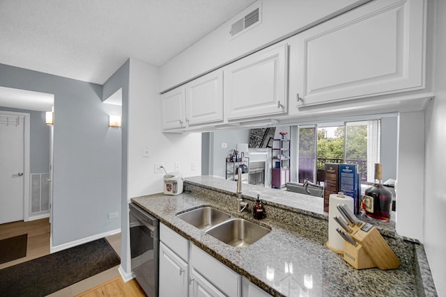 511 Aurora Ave Unit 413, Naperville, IL 60540 - kitchen featuring dishwasher, light wood finished floors, light stone counters, and white cabinetry
