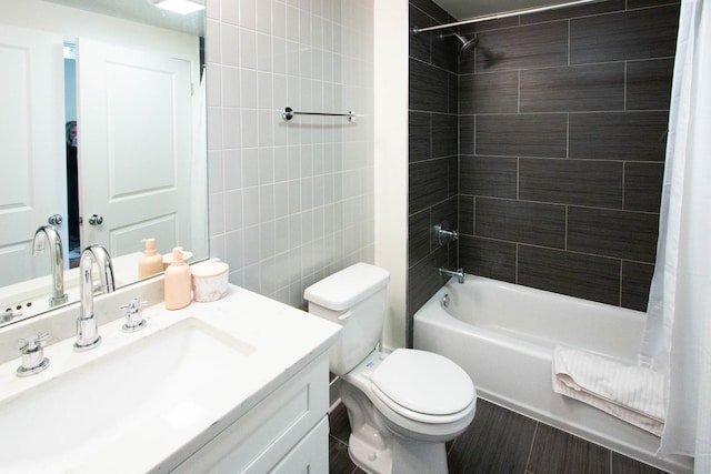 bathroom featuring shower / bathtub combination with curtain, toilet, vanity, wood finished floors, and tile walls