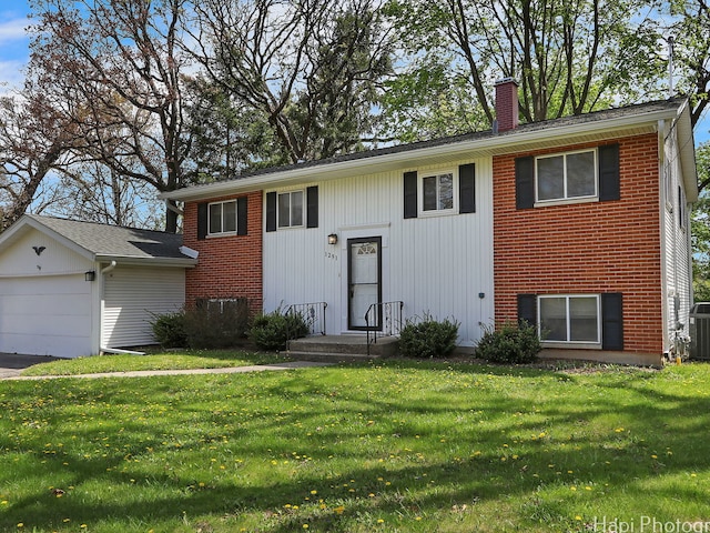 1291 Banbury Rd, Mundelein, IL 60060 - bi-level home featuring a chimney, a front yard, and central AC