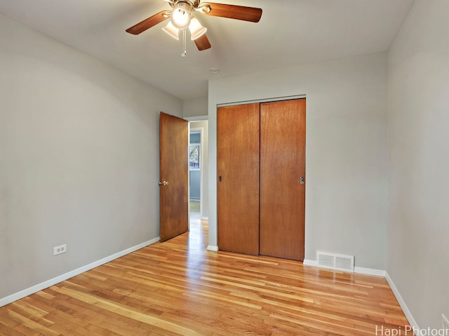 1291 Banbury Rd, Mundelein, IL 60060 - unfurnished bedroom with light wood-type flooring, baseboards, a closet, and a ceiling fan