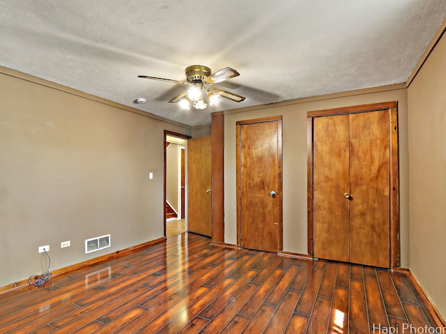 1291 Banbury Rd, Mundelein, IL 60060 - unfurnished bedroom featuring wood finished floors, multiple closets, baseboards, and a ceiling fan