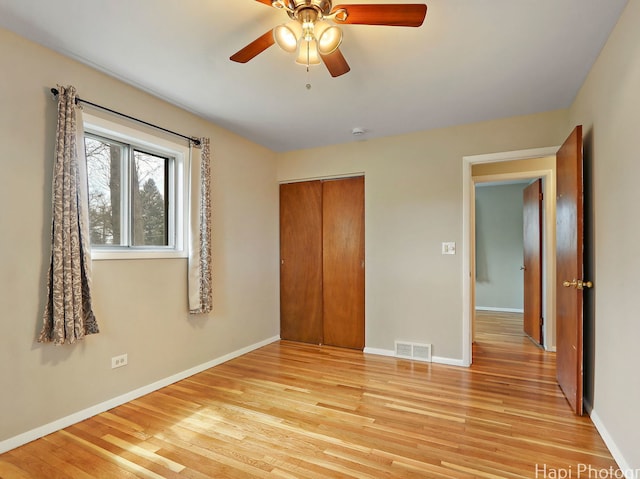 1291 Banbury Rd, Mundelein, IL 60060 - unfurnished bedroom with light wood-style floors, a closet, baseboards, and a ceiling fan