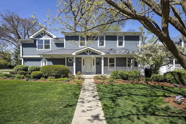 traditional-style home featuring a front yard and a porch