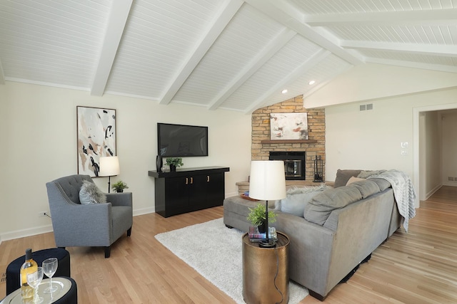 living area featuring a fireplace, light wood-style flooring, and baseboards