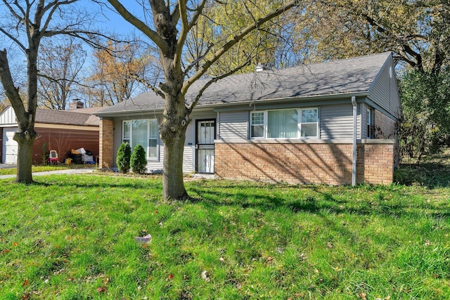 ranch-style house featuring brick siding, a front lawn, and a garage