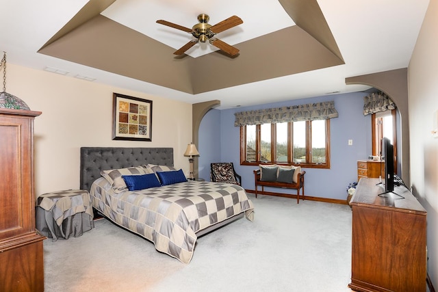 15521 S Mallard Ln, Homer Glen, IL 60491 - bedroom with arched walkways, a tray ceiling, light colored carpet, and baseboards