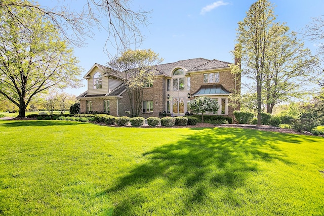 15521 S Mallard Ln, Homer Glen, IL 60491 - view of front facade with brick siding, a chimney, and a front yard