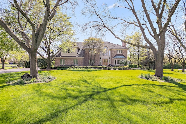 15521 S Mallard Ln, Homer Glen, IL 60491 - view of front of property featuring brick siding, a front yard, and a chimney