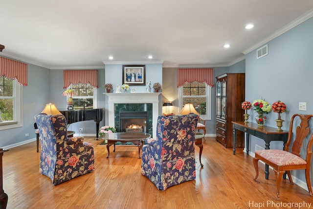 2114 Prairie St, Glenview, IL 60025 - living room featuring a fireplace, plenty of natural light, wood finished floors, crown molding, and recessed lighting