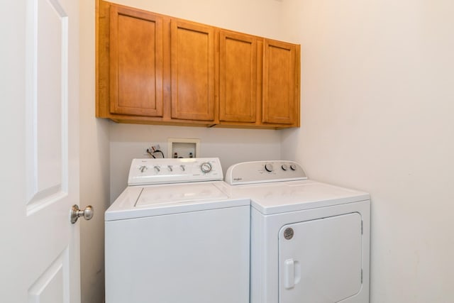 laundry area featuring washing machine and dryer and cabinet space
