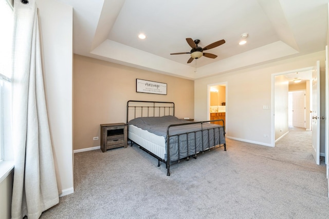 bedroom featuring a tray ceiling, carpet flooring, baseboards, a ceiling fan, and recessed lighting