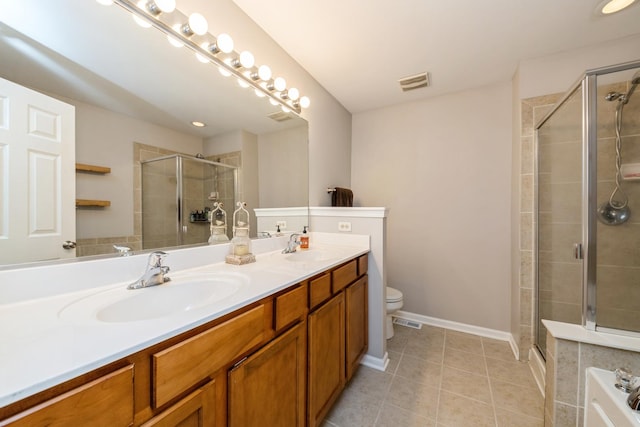 bathroom with a stall shower, toilet, tile patterned flooring, double vanity, and baseboards