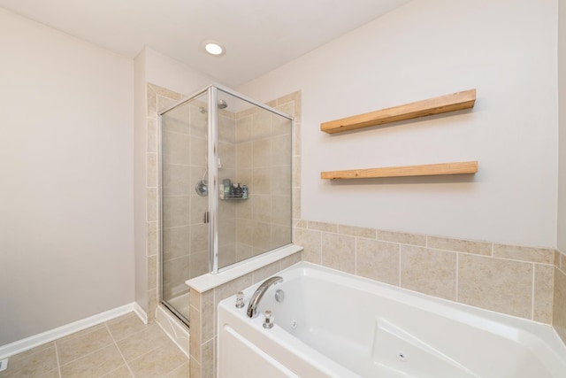 bathroom featuring a shower stall, a garden tub, and tile patterned floors